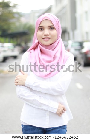 Beautiful Asian women in pink hijab with street style fashion.