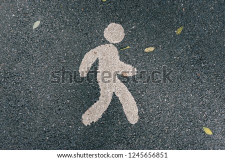 A symbols of running and walking on the asphalt street at the park