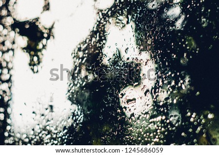 raindrops on the window.water drops close-up on glass .tinted photo, abstract background. flow down the glass