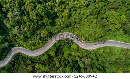 aerial view road curve construction up to mountain  Royalty-Free Stock Photo #1245688942