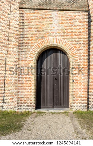 Europe, Belgium, Bruges, Staple Bend Tunnel, a bench in front of a brick building with Staple Bend Tunnel in the background