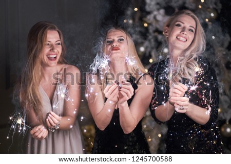 Picture showing group of friends having fun with sparklers