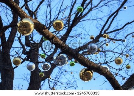 Christmas and new year decorations of houses and yard area. Christmas trees and trees are decorated with balls and toys. Festive mood is in the air