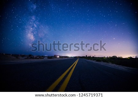 Milky way long night exposure on a shoreline roadway in summer along Vineyard sound Cape Cod