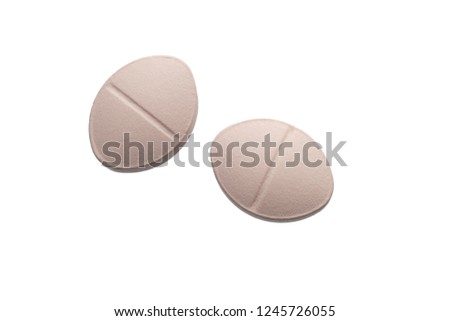 Pink pills isolated on white background