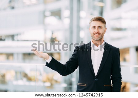 Businessman pointing and holding a palm up. The template for business design.