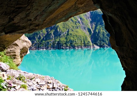 View of an turquoise lake from a cave