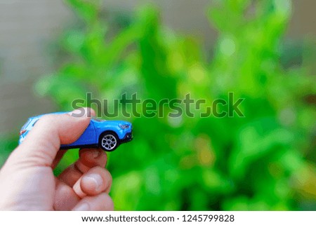 small car in hand,transportation concept,insurance concept