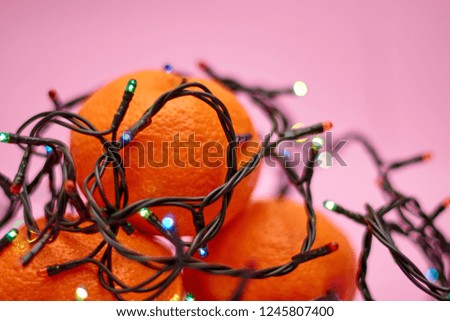 Mandarins and garlands lights. Christmas mood