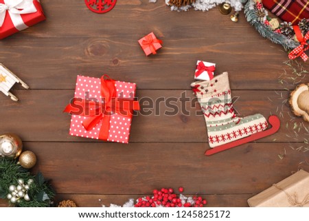 New year theme skate boot and different sized present boxes isolated on wooden table top view close-up