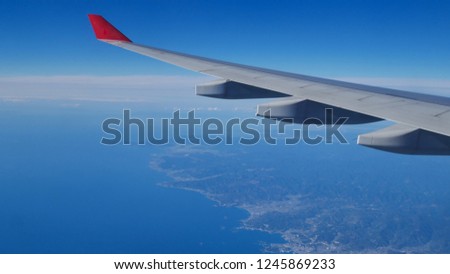 Red air plane on blue sky background.