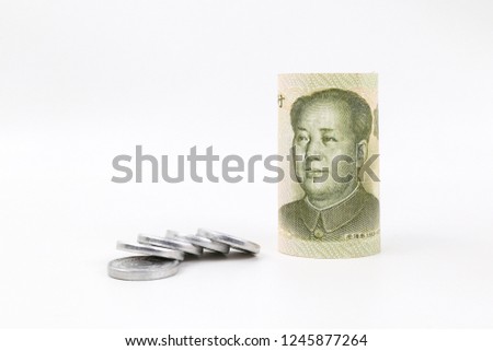 Yuan banknote from China's currency 
with coins isolated on white background.