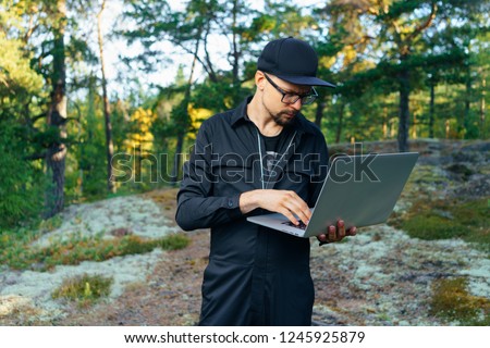 portrait of young traveler rock climber on the background of spellbinding landscape of Norwegian nature with high charming mountains and hills in which it is impossible not to fall in love work on lap
