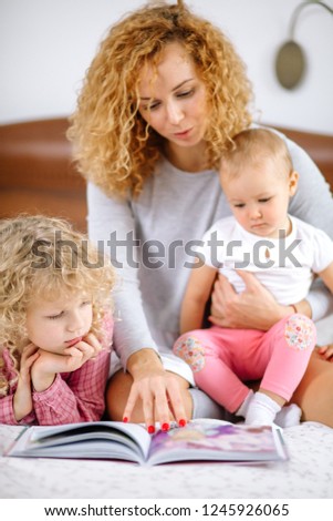 young woman teaching her children the English language. lesson concept. school at home.close up photo