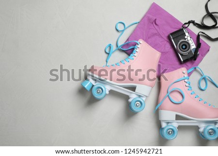 Flat lay composition with quad roller skates and space for text on light background