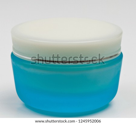 plastic container with cream on a white background. 