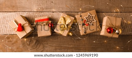 Christmas background with gift boxeson vintage wooden background. Classic Preparation for holidays. Top view with copy space.
