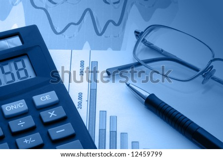 Business accessories on a background of diagrams.