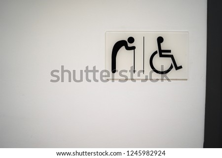 restroom Signs for the Elderly and the Disabled on white wall