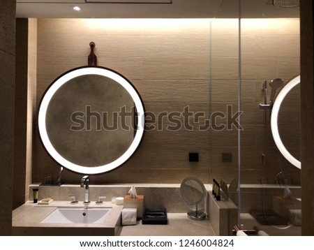 cosmetic mirror lighting of vanity unit in the hotel bathroom