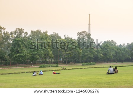 People relaxing in the park at sunset