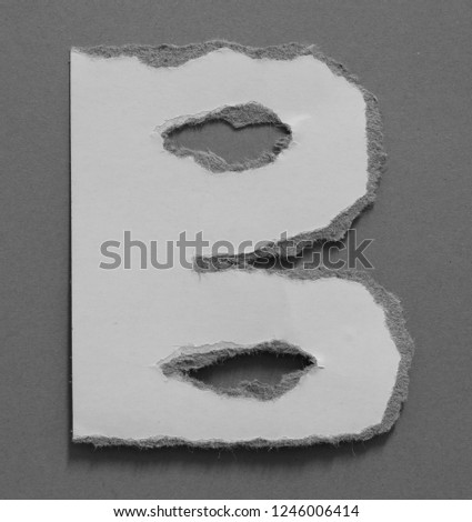 alphabet letters recycled torn paper craft on gray paper background (B)