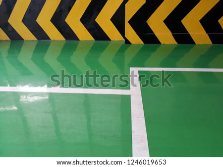 Coat the floor with acrylic green, white strip, yellow label on the wall.