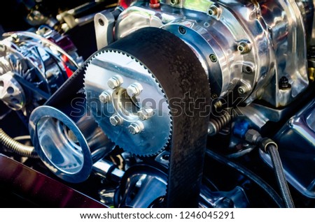 Close-up of a hot rod engine supercharger reflecting the colors of the car Royalty-Free Stock Photo #1246045291