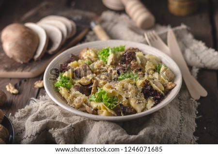 Homemade tortellini with mushrooms and walnuts, simple food photography with on vintage napkin