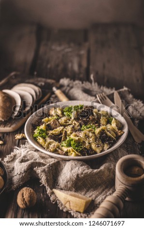 Homemade tortellini with mushrooms and walnuts, simple food photography with on vintage napkin