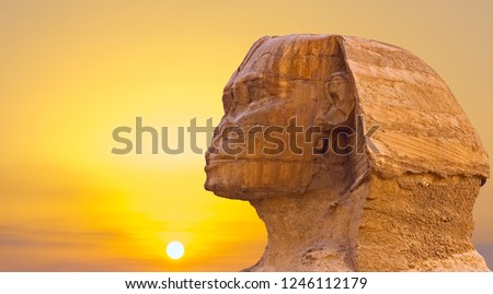 Sphinx head against the yellow sky, space for your text Royalty-Free Stock Photo #1246112179