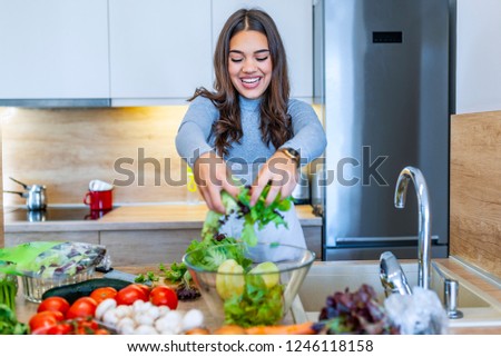 The woman in the process of making vegetable salad. Healthy Eating. Diet Concept. A Healthy Way Of Life. Cook At Home. To Prepare The Food. Girl mixing salad .