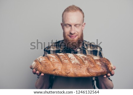 Portrait of nice-looking calm peaceful man in checkered casual shirt stand isolated on light gray background close eyes hold big pastry in hand from manufacture breath aroma