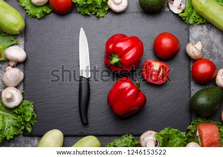 Sweet pepper, tomatoes, mushrooms, avocados, zucchini and salad with knife. Cooking process concept, top view Royalty-Free Stock Photo #1246153522