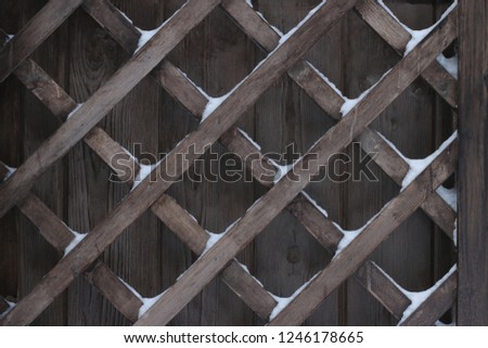  The wooden grid background cross wood under snow. dark wood background