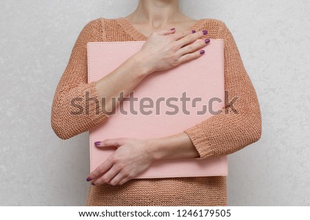 
a woman holds a photobook
 photo book with  leather cover
Wedding photo album.
sample photobook
the person is looking at a photobook