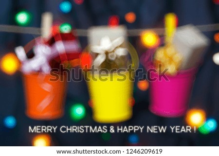 gifts boxes in buckets of colored garlands on lights background. Merry Christmas and Happy New Year card
