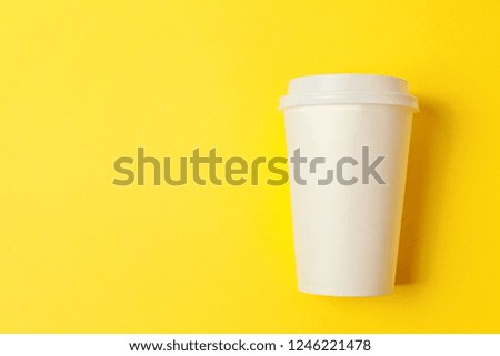 Simply flat lay design paper coffee cup on yellow colorful trendy background. Takeaway drink container. Good morning wake up awake concept. Template of drink mockup. Top view copy space