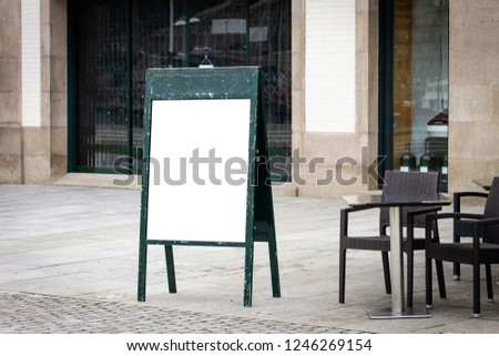 Restaurant cafe outdoor stand-up menu green sign mockup. Chairs and table on terrace.