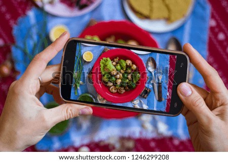 Take phone food photo with smartphone in woman hands, Photography for blogging, mobile social media publications and posts for cafes, restaurants. Baked roasted grilled vegetables. 