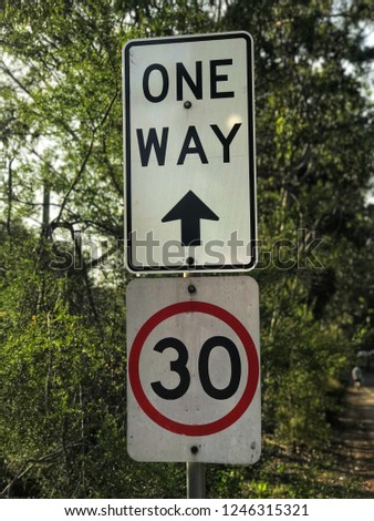 The safety sign in the park indicate the speed limit to 30 and one way only