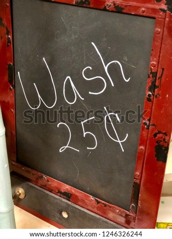 Close up of chalkboard with red frame reading - wash twenty five cents
