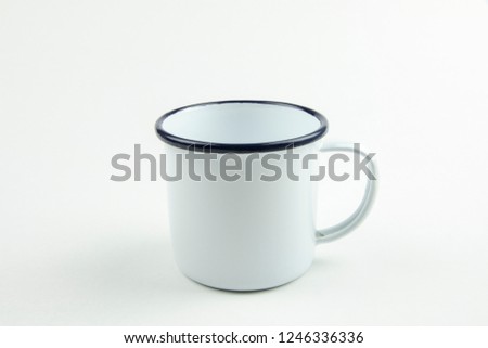 White tin cup on white background.