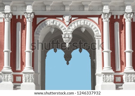 Architectural building with arches, stucco, pilasters.