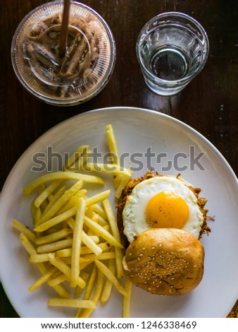 Pull Pork burger With French Fries on the white plate and ice chocolate.