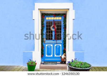 Blue-painted wall and blue door with Christmas decoration 