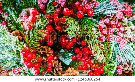 Beautiful Christmas ornaments. Christmas decoration in the form of branches Christmas tree with red berries, pine cone.