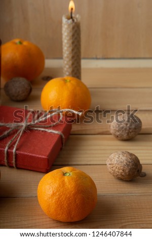 Festive table. Tangerines and nuts on the wooden table.