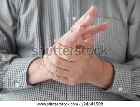 a man tries to restore feeling in his hand by squeezing
