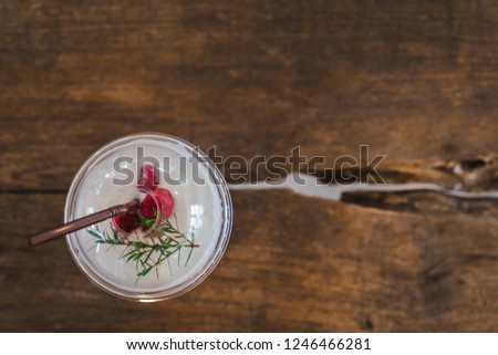 Fresh rasberry cream soda, cold drink or beverage with ice on  wooden background, top view